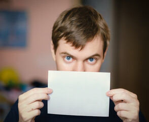 Adult man with white blank paper in hand. - 763955117