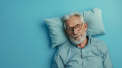 Elderly man sleeping on pillow isolated on pastel blue colored background Sleep deeply peacefully rest. Top above high angle view photo portrait of satisfied .senior wear blue shirt