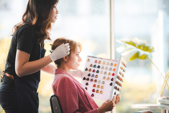 Choice of Hue: Client Ponders Hair Dye Options at Salon for the Perfect Color Transformation - Powered by Adobe