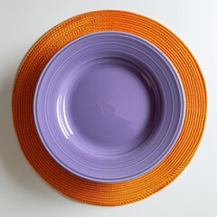 Top-View Minimalist Violet Purple Plate on Orange Circular Mat


