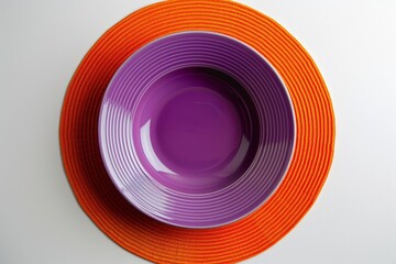 Fototapeta premium Top-View Minimalist Violet Purple Plate on Orange Circular Mat
