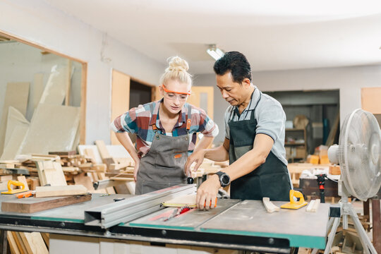 In a carpenter's shop, skilled craftsmen engage in woodwork, creating furniture with tools in a workshop, blending industry training and craft.