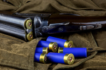 Vintage Shotgun with Shotgun Cartridges on an Outdoor Field Coat - 763968108