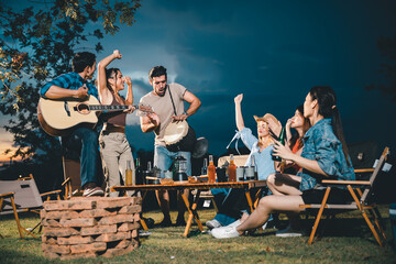 summer party camping of friends group with guitar music, happy young woman and smiling man having...