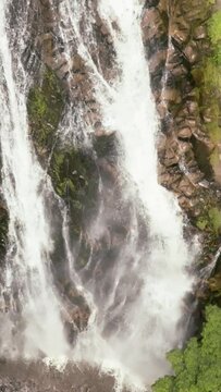 Top view of beautiful Efrata waterfall in the mountains in slow motion. Samosir, Indonesia. Vertical video.