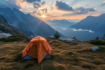 Orange tent on the top of the mountain at sunset,  Camping in the mountains - obrazy, fototapety, plakaty