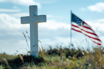 White cross on a hill with grass and USA flag, memorial day.