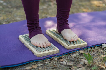 Close up of woman's legs after standing on sadhu board