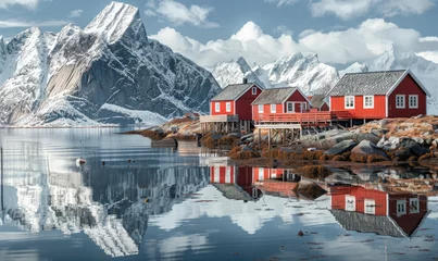 Deurstickers Red wooden houses of Reine, Lofoten Islands in Norway with snowcapped mountains behind them and clear blue sky. A small fishing village near the sea surrounded by rocks and reflections on water. © Kien