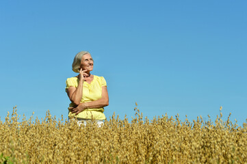 Naklejka na ściany i meble Portrait of senior woman in summer field