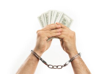 Close-up of man in handcuffs showing money as illegal concept