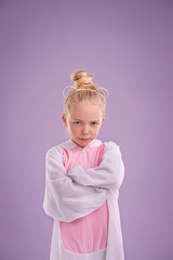 Girl, bunny and plush with attitude, studio and arms crossed for easter. Child, costume and youth with pastel, rabbit and grumpy for holiday with childhood dress up isolated on purple background