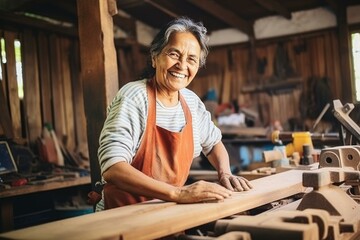Carpenter woman one smile young aged standing aim working on wood plank in carpenter workshop. Latin female carpenter entrepreneur working craft with wood DIY tool in workbench carpenter workshop