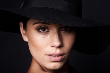 Woman, face and fashion with hat for beauty, mob or classic gangster style on black background....