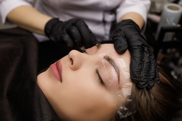 In the hands of the master tattoo machine which he performs correction of permanent eyebrow makeup....