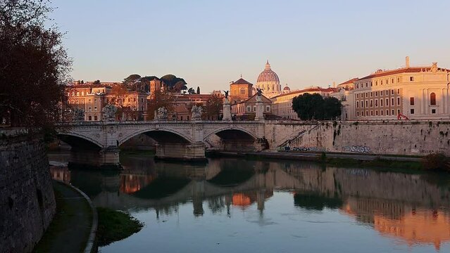 View of St. Peter's Basilica in Vatican, Tiber River and Aelian Bridge in early morning skyline at sunrise, idyll, Rome, Italy. Video filmed handheld. High quality FullHD footage