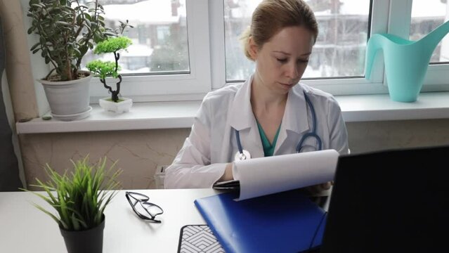 Doctor processing medical insurance, completing patient coverage, health form