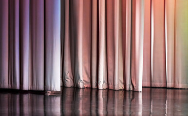 Closed white wavy curtain under colorful illumination