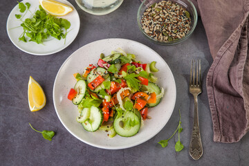 Salad of fresh cucumbers, celery, sweet peppers, herbs and pumpkin seeds, sunflowers, sesame seeds with olive oil. Healthy vegetarian, vegan food. Italian Cuisine