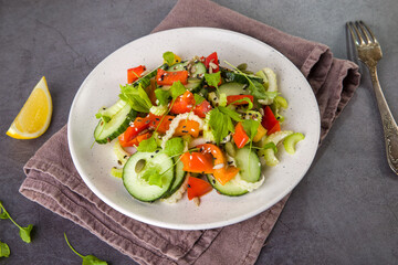 Salad of fresh cucumbers, celery, sweet peppers, herbs and pumpkin seeds, sunflowers, sesame seeds with olive oil. Healthy vegetarian, vegan food. Italian Cuisine