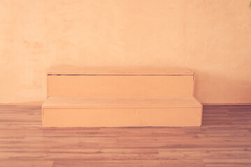 Podium scene in the form of ladder for placing goods, products for advertising. Mock up, template for presentation, show product. Background with copy space, peach fuzz color. Concept for your design.