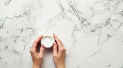 Hand with moisturizers against marble background