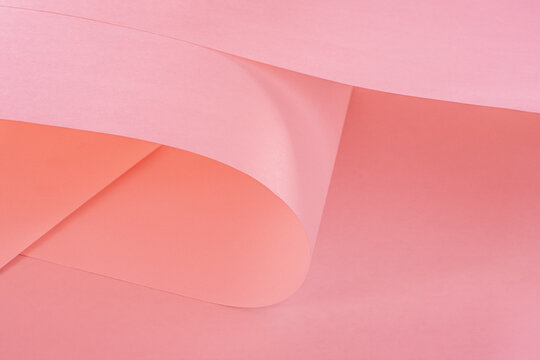 A large long piece of warm pink paper as a background.