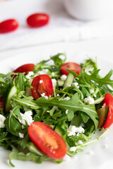 Green vegan salad with arugula leaves and cherry tomatoes. Snack, food