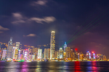Fototapeta na wymiar Hong Kong at night light show on skyscrapers near the bay