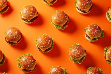 Wallpaper with a bunch of burgers on orange background. Lots of tasty burgers, yummy screen saver. Fast food backdrop.