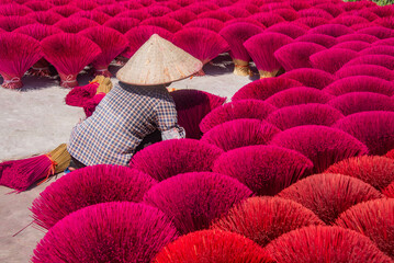 Worker drying incense in the Quang Phu Cau incense village, Hanoi, Vietnam