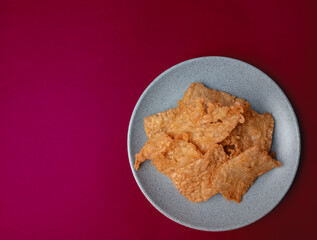 Tempe goreng. Delicious fried tempeh from Indonesia Asian culinary isolated on red background