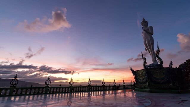Timelapse of temple and big Buddha statue at sunrise. Time lapse of Buddha statue in Wat khao phra kru temple located in Sriracha city, Chonburi, Thailand. Footage b-roll 4k. Religion and travel.