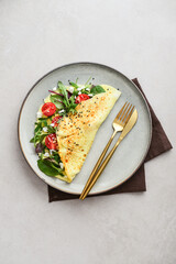 Omelette with herbs, feta cheese and cherry tomatoes - 764036935