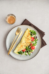 Omelette with herbs, feta cheese and cherry tomatoes