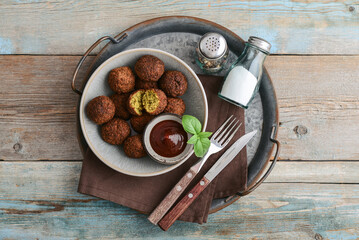 Falafel plate with spice and souce on metal tray - 764036995