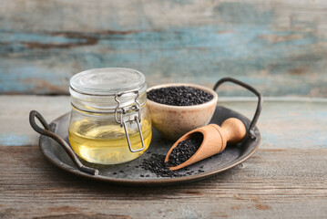 Black sesame seeds in bowl and oil in glass jar - 764037187