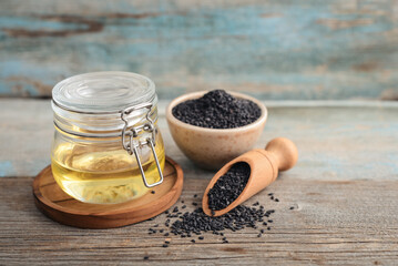Black sesame seeds in bowl and oil in glass jar - 764037199