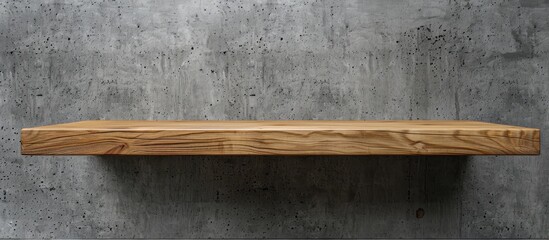 Naklejka na ściany i meble A rectangle wooden shelf made of hardwood is attached to a concrete wall. The wood stain highlights the natural material, creating a beautiful pattern against the grass flooring