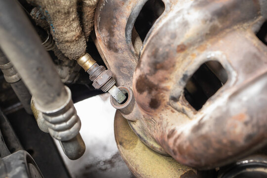 Old oxygen sensor or lambda probe of a passenger car to be replaced, close-up