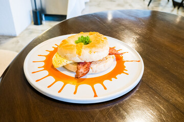 Fresh healthy bagel with egg and bacon for breakfast.