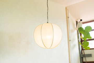 White Japanese lantern hanging at restaurant.