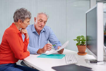 Paperwork, planning and senior woman with financial advisor in discussion for pension fund in...