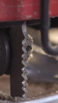 Delve into the world of woodworking mastery with our stunning 4K vertical slow motion footage capturing the intricate process of a jigsaw shaping wood with meticulous detail. Ideal for highlighting th