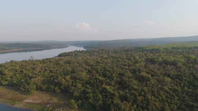 Drone shot aerial view scenic landscape of big river dam and forest against blue sky