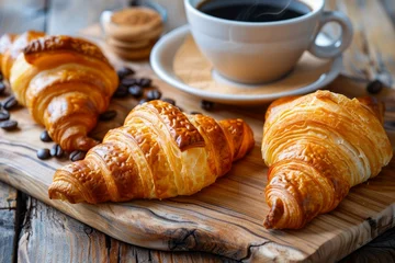  Freshly Baked Croissants on Wooden Cutting Board with Black Coffee Cup and Coffee Beans © pisan