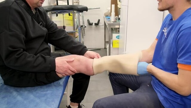 Preparing and fitting a bionic leg for a patient at a rehabilitation center. Healthcare, modern developments.