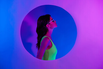 Profile side photo of girl with sunglass standing in circle hole isolated color neon vivid background