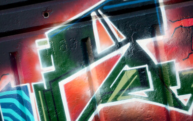 Colorful background of graffiti painting artwork with bright aerosol outlines on wall. Old school...