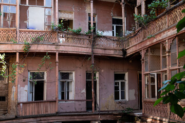 Fototapeta na wymiar Interior courtyard of an abandoned apartment building in Old Town, Tbilisi, Georgia.